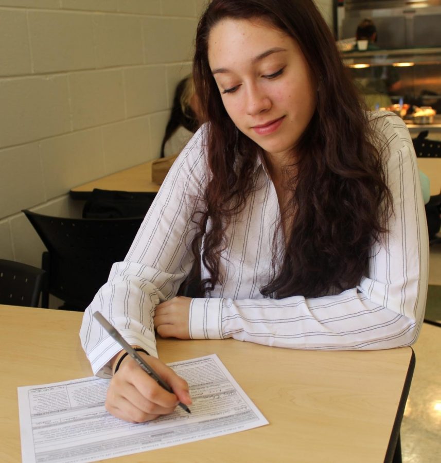 Salzman, 12, fills out an ROTC form for the U.S. Air Force nurse program.