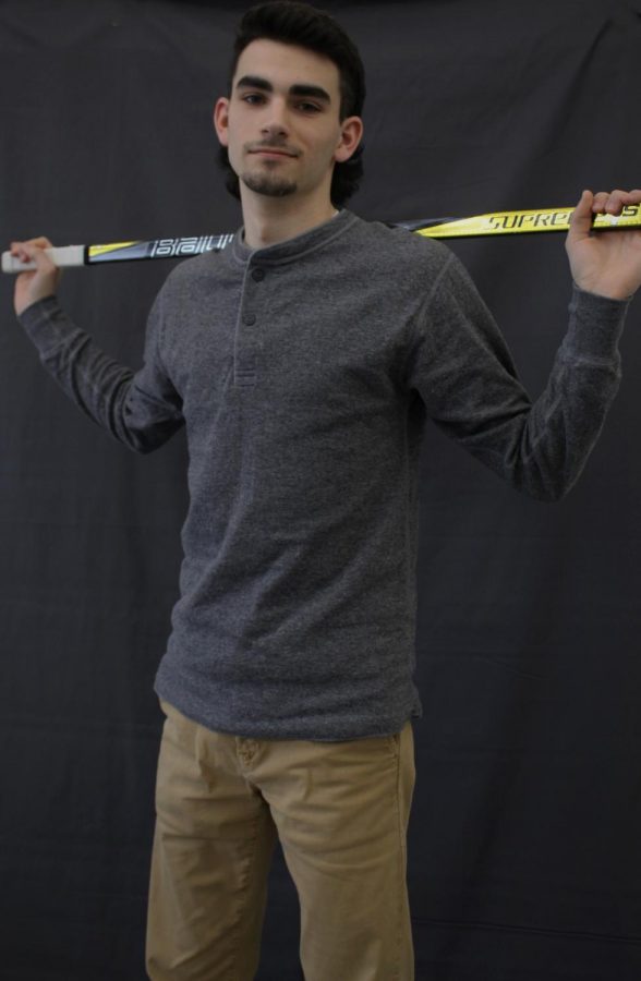Jack Krawet, 12, stands tall with his hockey stick over his shoulders.