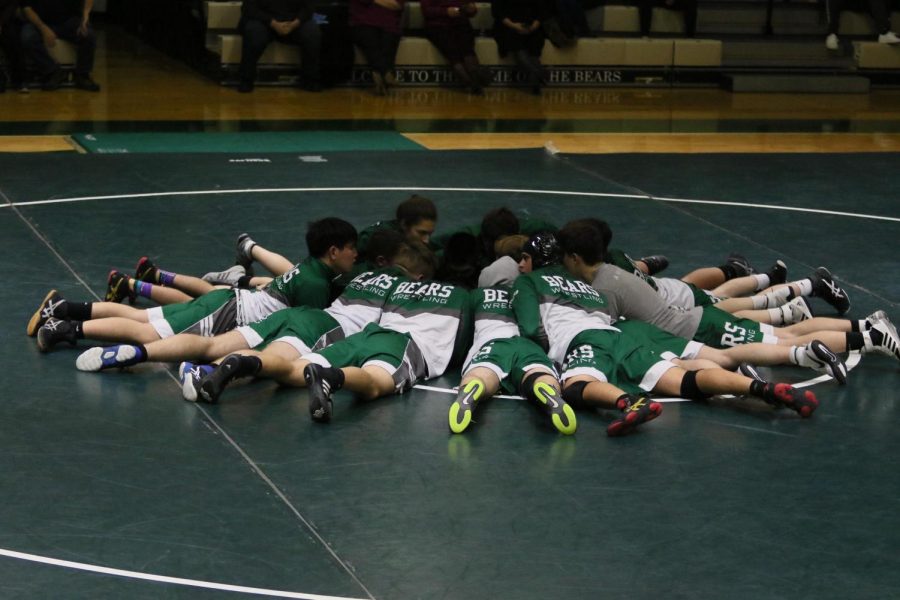The EBHS Wrestling team huddles up on the mat together before their match against Edison High School.