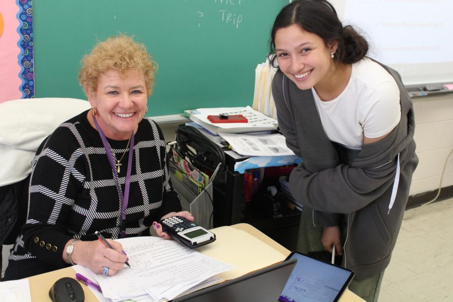 Statistics Teacher Ms. Hughes helps Ysabella Sapienza, 12, with the empirical formula. “Definitely physically in class, for sure” Ms. Hughes says, when asked where students ask the most questions.