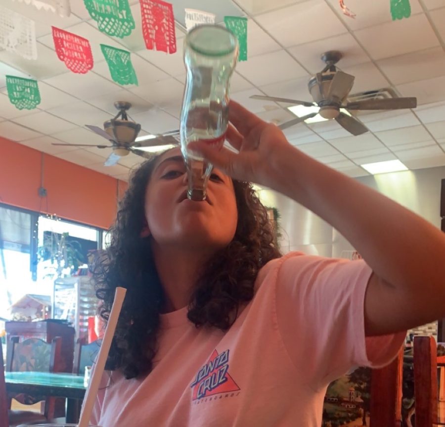 Rebecca Perez (12) enjoys a nice cold Coke-Cola bottle in La China Poblana, after a long day of school.

