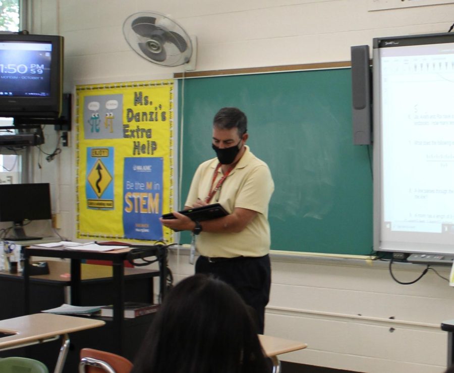 Mr. Elias teaches a mathematics lesson while incorporating OneNote. 