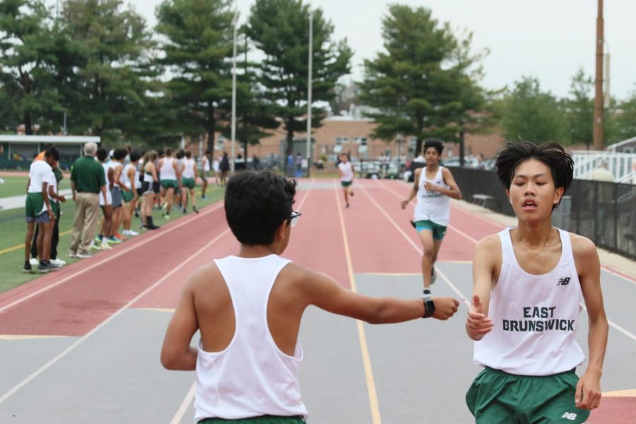 ABOVE  Anurag Lohani 9thhands Matthew Chu 10th his placing as he finishes his 5k run during senior night triumphantly. 
