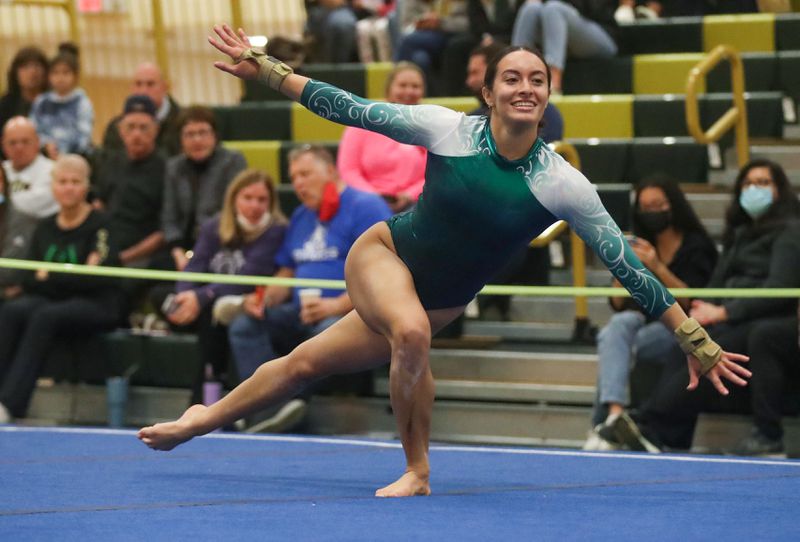 Senior Karina Munoz smiles after showing off her skill on the floor event. The floor event is actually senior Sydney Yu’s favorite event because it is “the event you get to show the most personality since you get floor music and choreography.” 