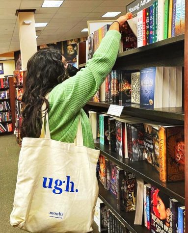 Senior Reva Bahuguna scours the shelves of Barnes & Nobles, looking for one of the 400 books she plans to read this year.
