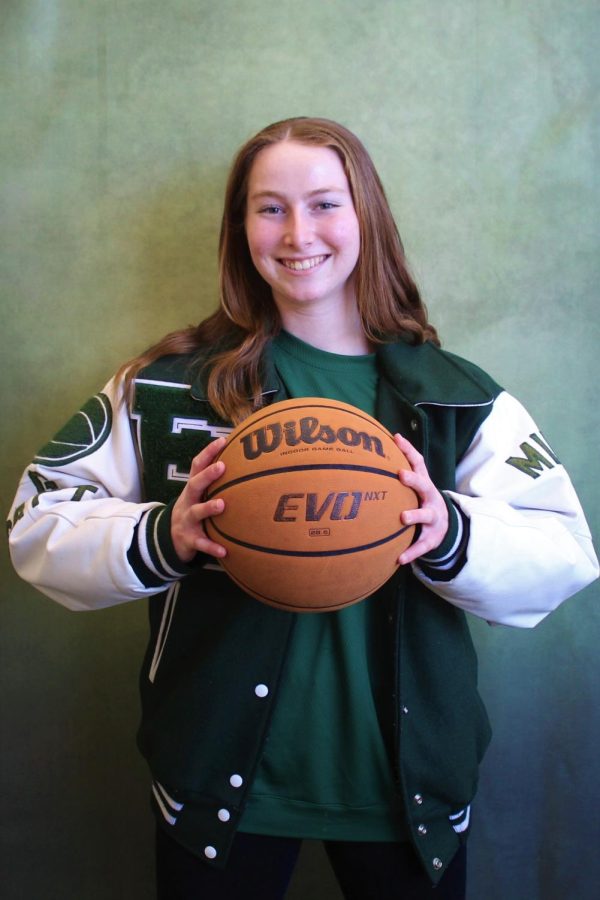 Samantha Lederman, 12, flexes her varsity basketball jacket in which she earned her junior year. She also became the captain of the girls basketball team during her junior year. 