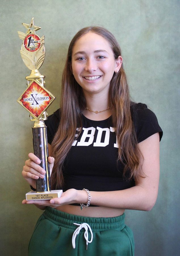Rachel proudly shows off her first place trophy from the competition Dance Xplosion.  
