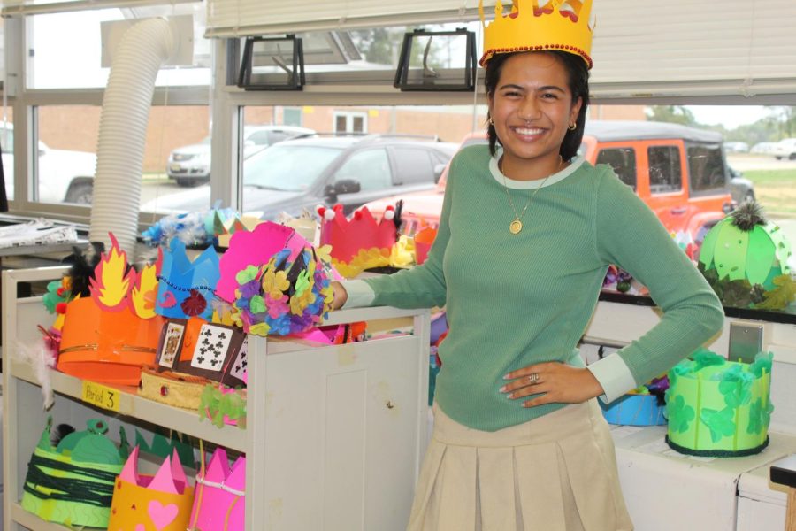 Quinn Salazar ( senior) posing with the crowns made by the Humanities students. 