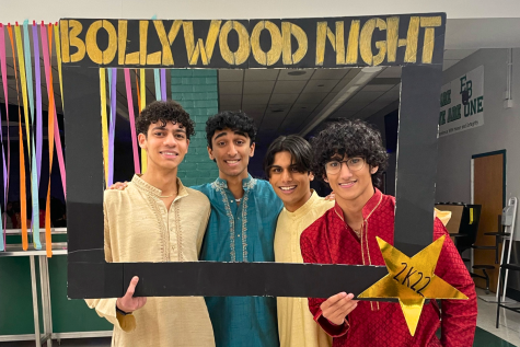 Mark, Arjun, Sunjay and Kashi pose with a Bollywood Night Prop 