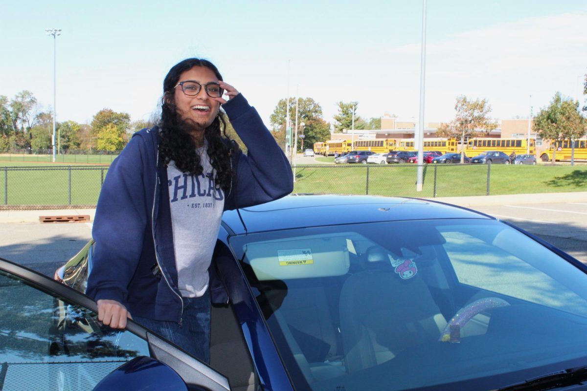 Senior Anika Chandra (12),  posing in her new car affectionately named “Whole Lotta Blues” or “Blues” for short.
