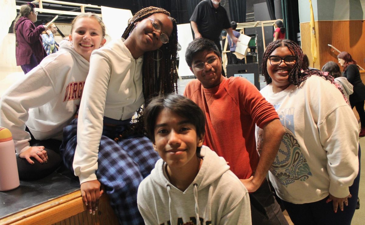 Mallory Blalock, 11, Michae Grant, 12, Kayden Acosta, 12, Dhruv Agrawal, 12, and  Kyla Noel, 11, take a break from rehearsing and pose for a quick photo.