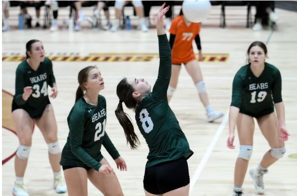 Seniors Kasey Trzaska, Julia Gawel, and Abby Wolfe work together to help senior Morgan Stoner to score a point for their team against Hillsborough. 

